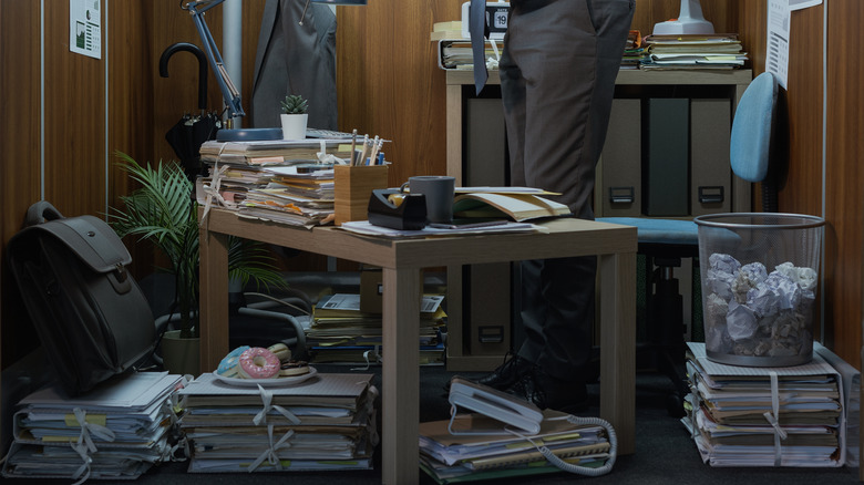 A man working in an incredibly cramped office.