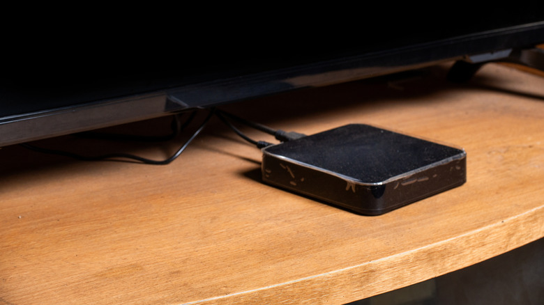A streaming box under a TV