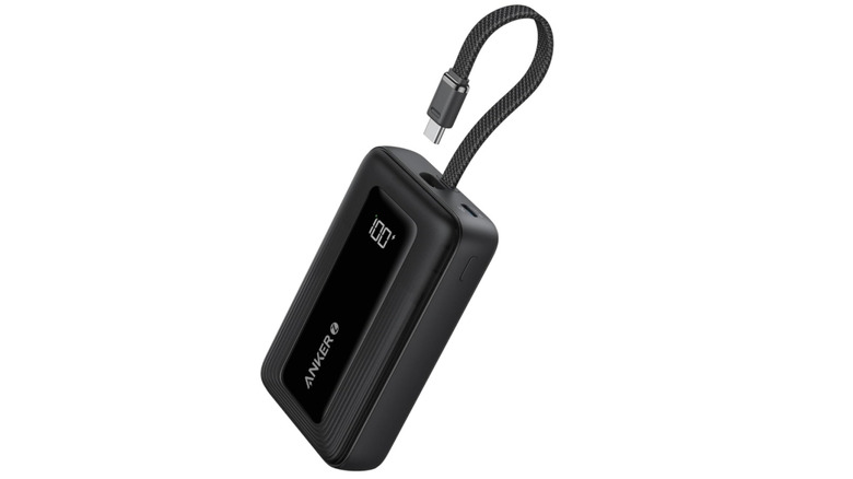 Debit card next to Anker charger showing size difference