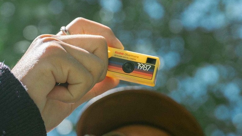A yellow Kodak Charmera Keychain Digital Camera held in a person's hand