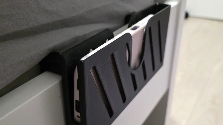 Bedside basket holder with a smartphone