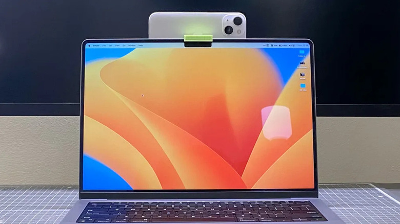 An iPhone mounted on a Macbook with a camera mount