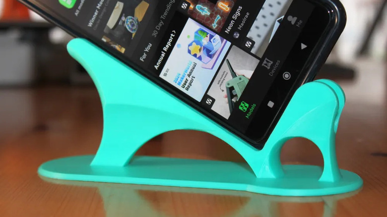 The BedEase Phone Stand holding a phone