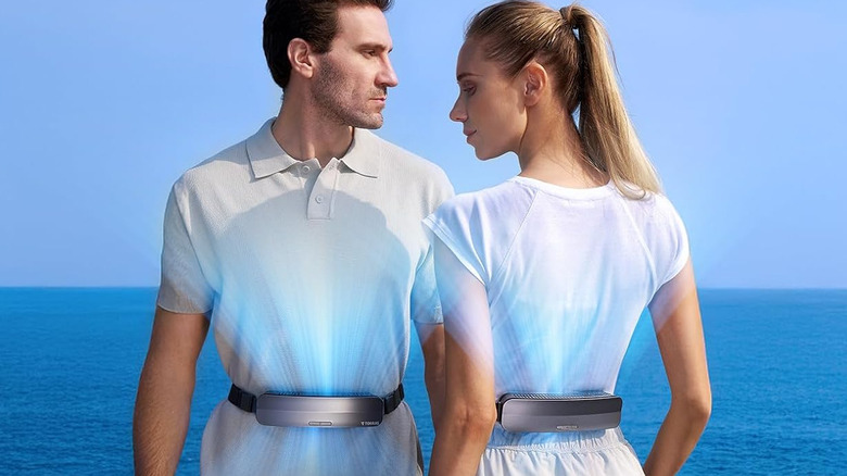 Two people wearing the Torras portable waist fan