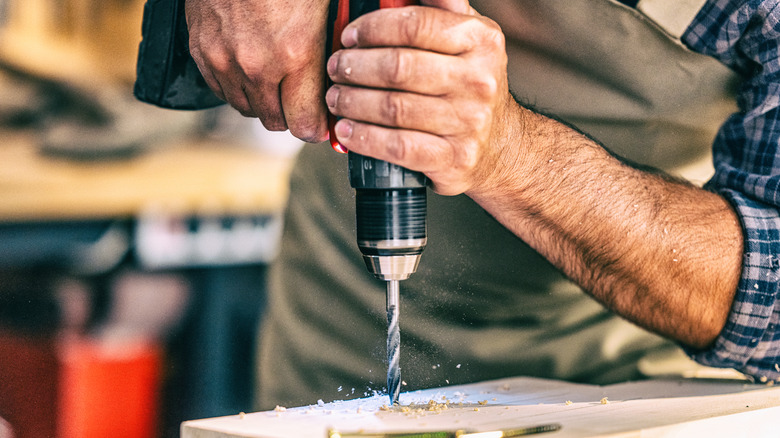 man using a drill