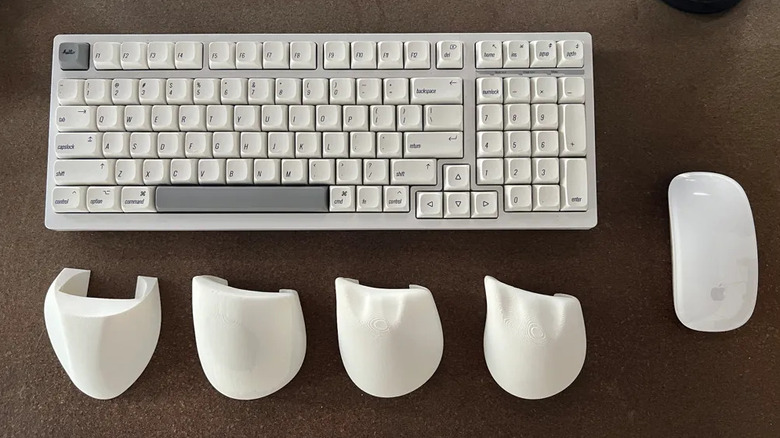 Ergonomic attachments next to the Apple mouse and a keyboard