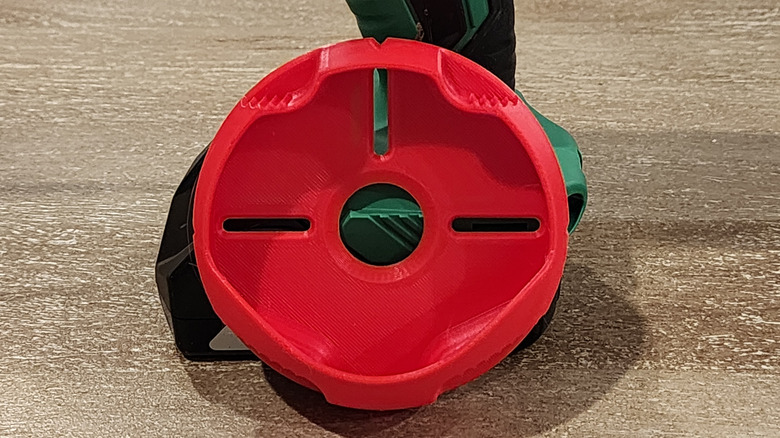 Drill Dust Collector propped up on a wooden surface