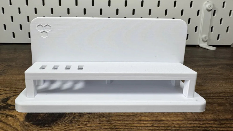 White laptop stand on a wooden desk