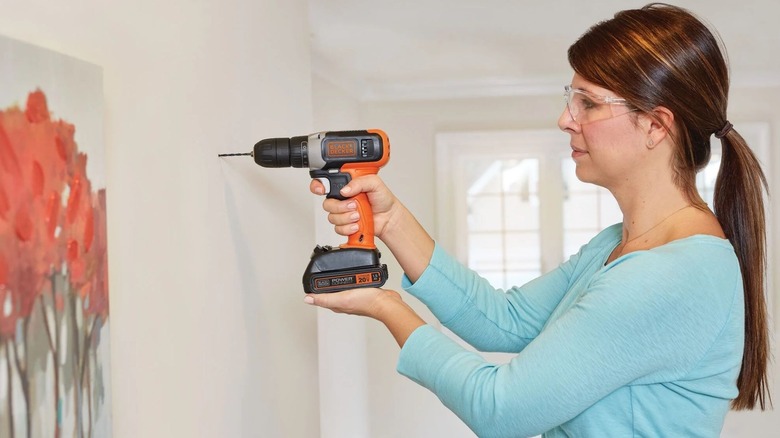 woman holding Black + Decker 20V Cordless Drill