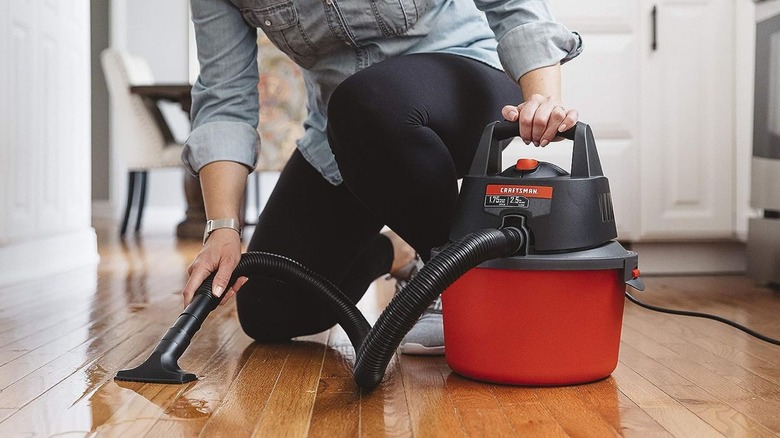 woman using Craftsman 2.5-Gallon Wet/Dry Vacuum on floor