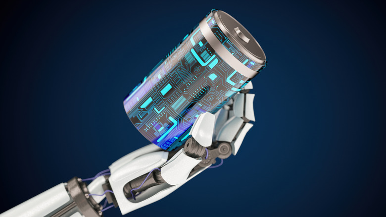 A robotic hand holding a battery over a blue background