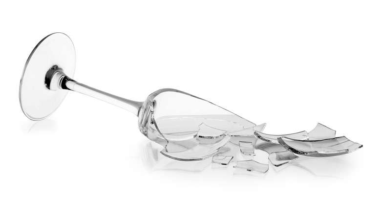 A broken champagne glass white background