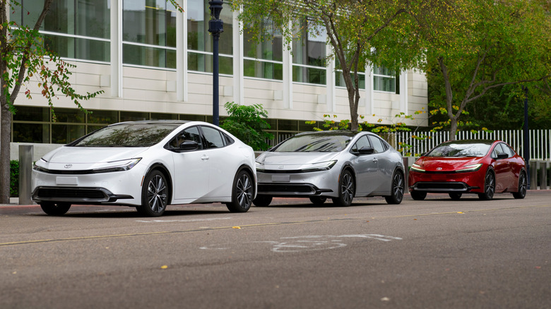 A trio of Toyota Prius cars parked next to each other