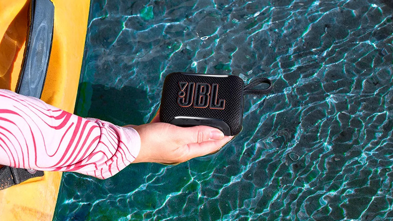 Holding the JBL Go 5 on top of a pool of water