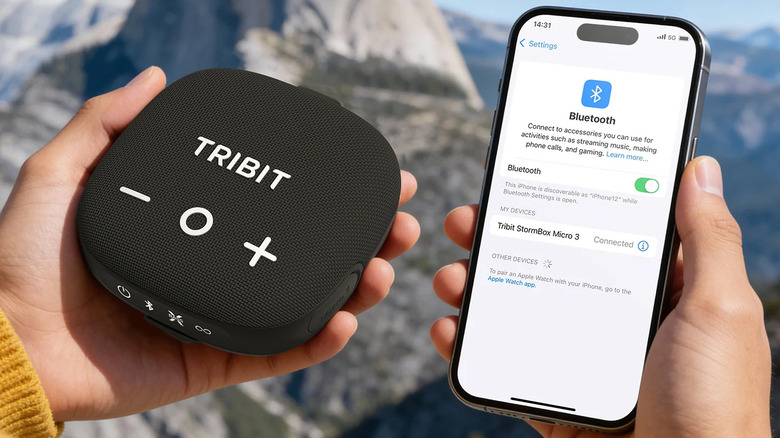 The Tribit StormBox Micro 3 speaker held next to an iPhone as a person tries to connect via Bluetooth