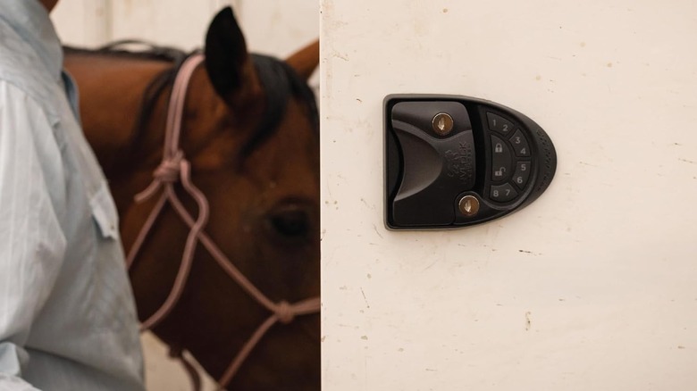 Closeup of a horse trailer door with a keypad lock