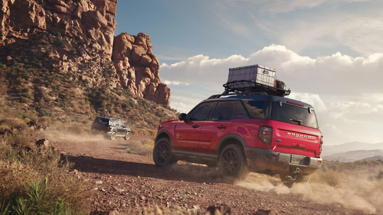 A red Ford Bronco Sport climbing a dirt trail
