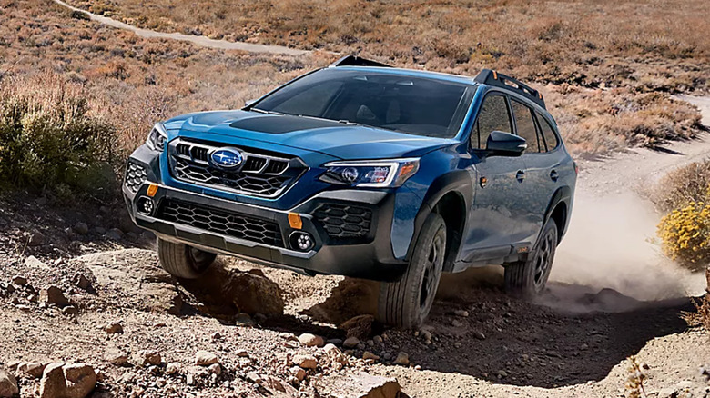 A blue Subaru Outback climbing a hill
