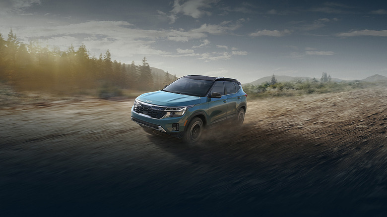A Kia Seltos driving on a dirt path