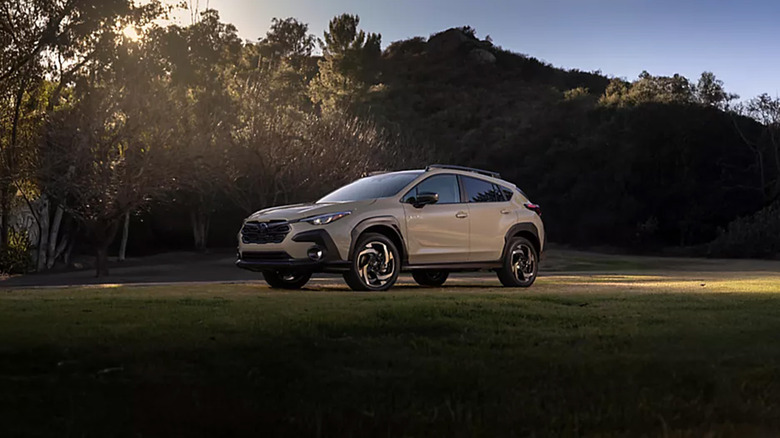 A silver Subaru Crosstrek parked near woods