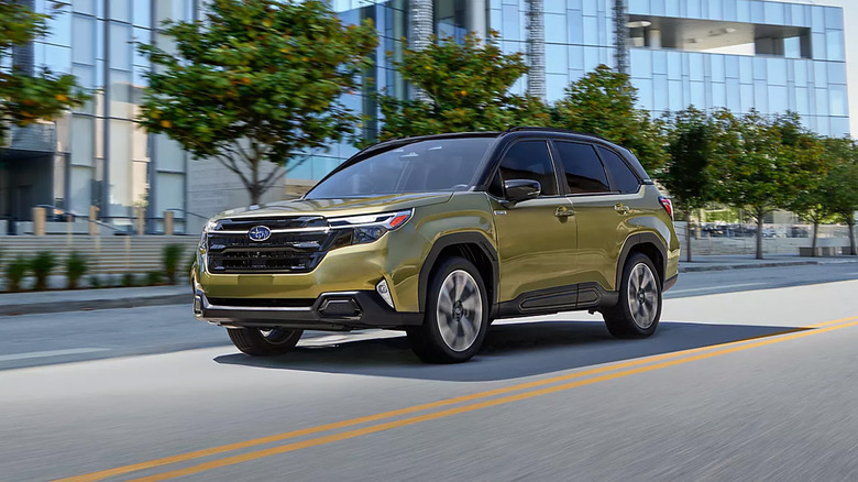 A green Subaru Forester driving on a city road