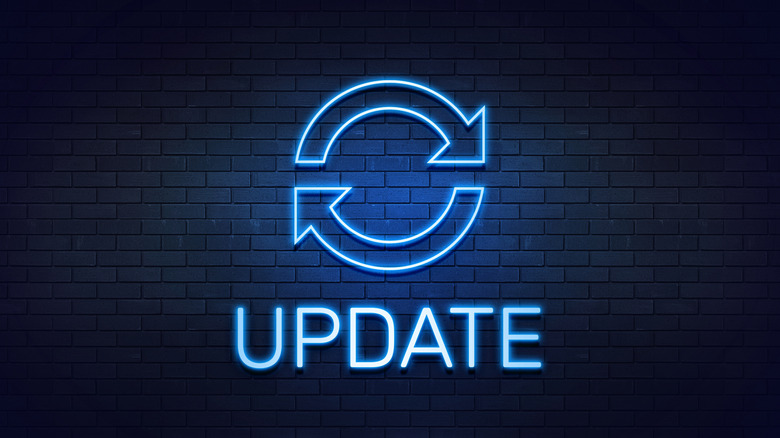 Blue neon update sign on brick wall