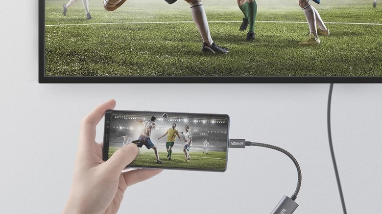 A phone connected to a TV using the Anker USB-C to HDMI adapter