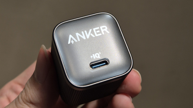 A person holding the Anker nano power adapter