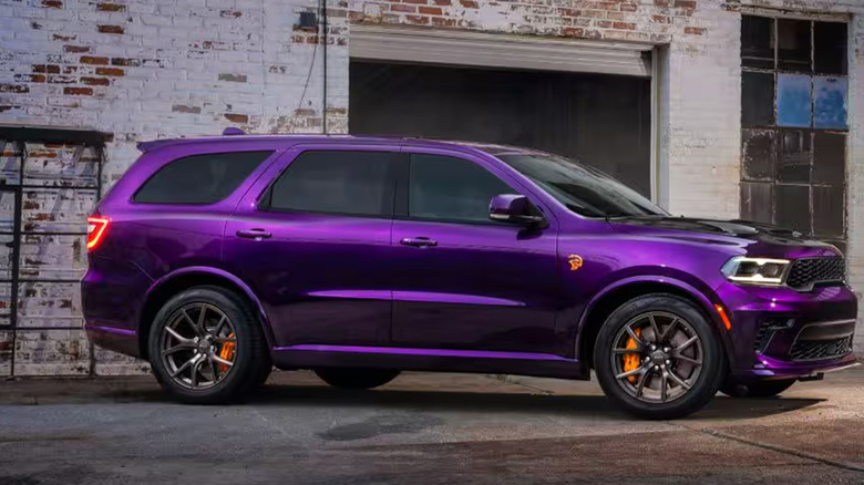 A purple Dodge Durango near a garage.