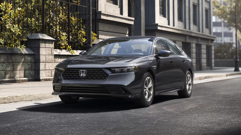A gray Honda Accord parked on a town street.