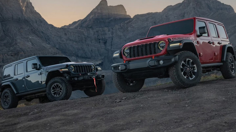 Two Jeep Wranglers on a mountain trail.