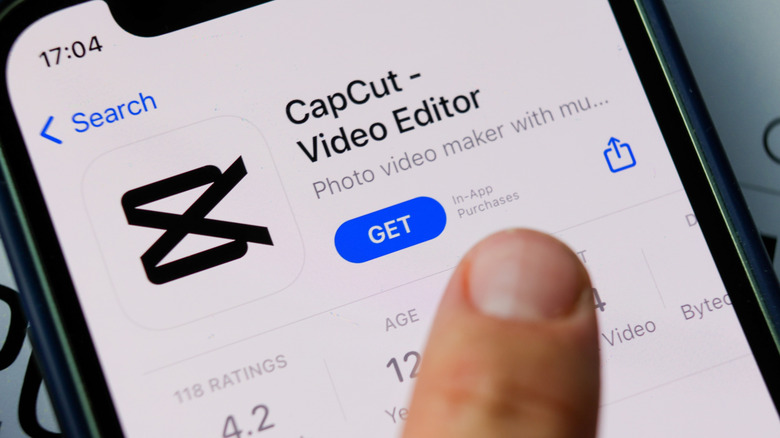 A person installing the CapCut video editor on an iPhone via the App Store