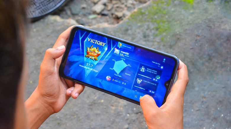 A person playing the Mobile Legends game on a smartphone