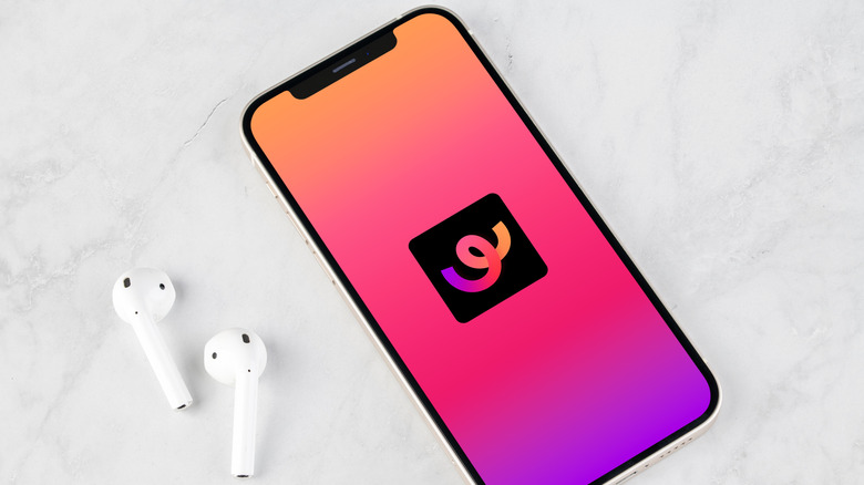 Whee app running on an iPhone with a pair of AirPods placed next to it