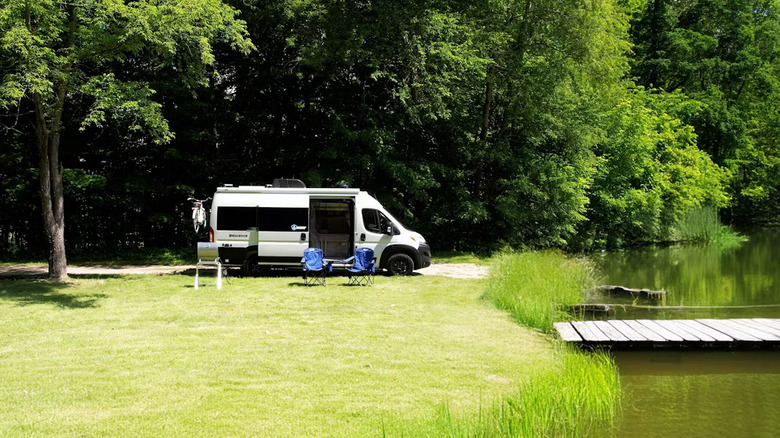 A white 2026 Thor sequence parked at the side of a lake