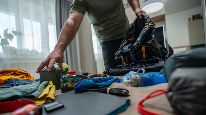 A man packing a backpack.