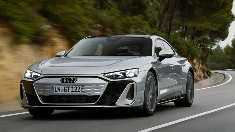 a silver Audi S E-Tron GT driving on a mountain road