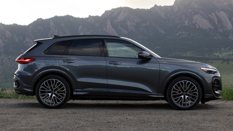 a dark gray Audi SQ5 parked in front of hills