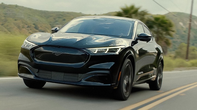 a black Ford Mustang Mach-E on a country road