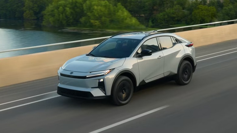a white Toyota C-HR on a bridge