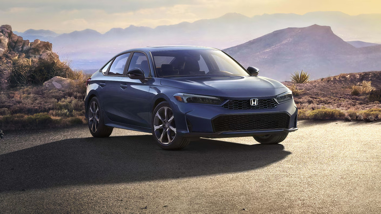 A gray Honda Civic parked near mountains