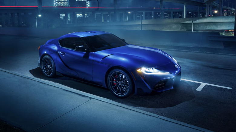 A blue Toyota GR Supra parked on a city street