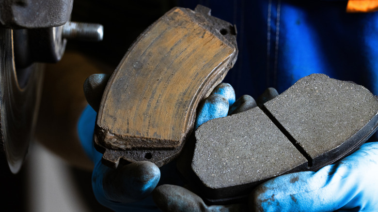Old and new brake pads for a car