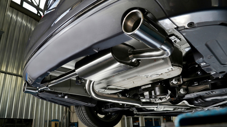 The bottom of a car focused on the muffler