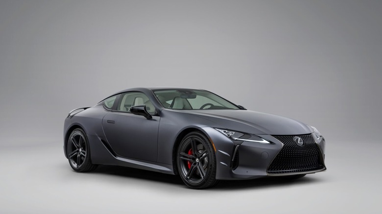 A gray 2026 Lexus LC500 sports coupe photographed here against a beige and gray studio background.