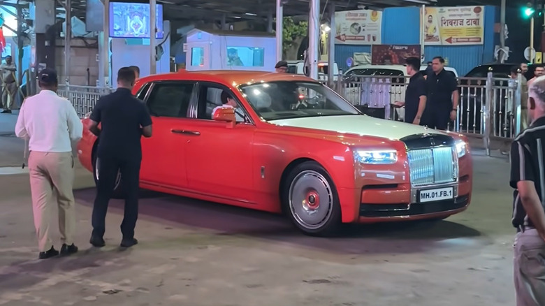 Anant Ambani's orange Rolls-Royce Phantom in the street