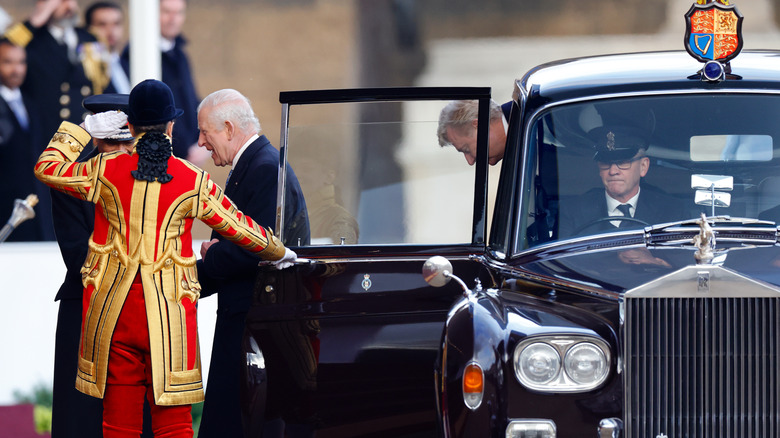 King Charles III exits his Rolls-Royce Phantom VI