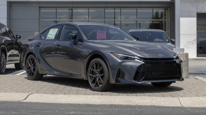 Black 2026 Lexus IS 350 marked for sale parked in front of a dealership