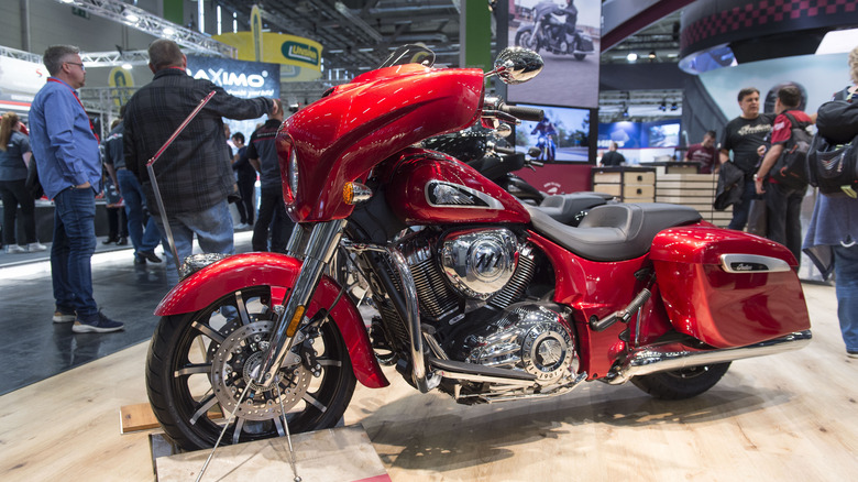 A red Indian Chieftain motorbike on display indoors at a motorbike show in Germany, from 2018.