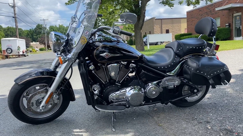 A Kawasaki Vulcan 2000 from 2006 parked in the shade.